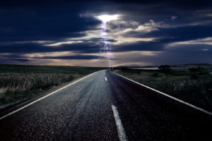 Lightning on the car road ahead