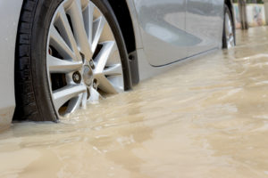 Cars Driving On A Flooded Road