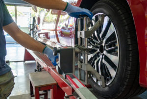 auto technicians performing wheel alignment